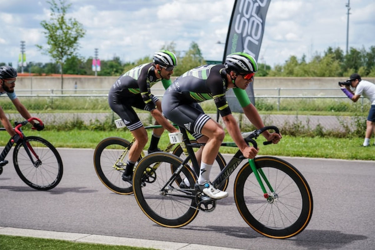 Men Cycling On Track