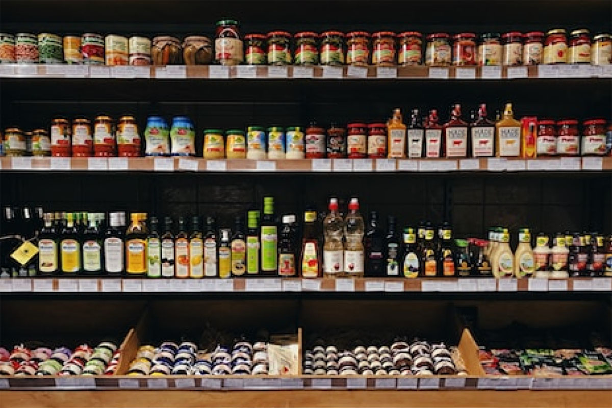 Store Shelf With Canned And Bottled Goods