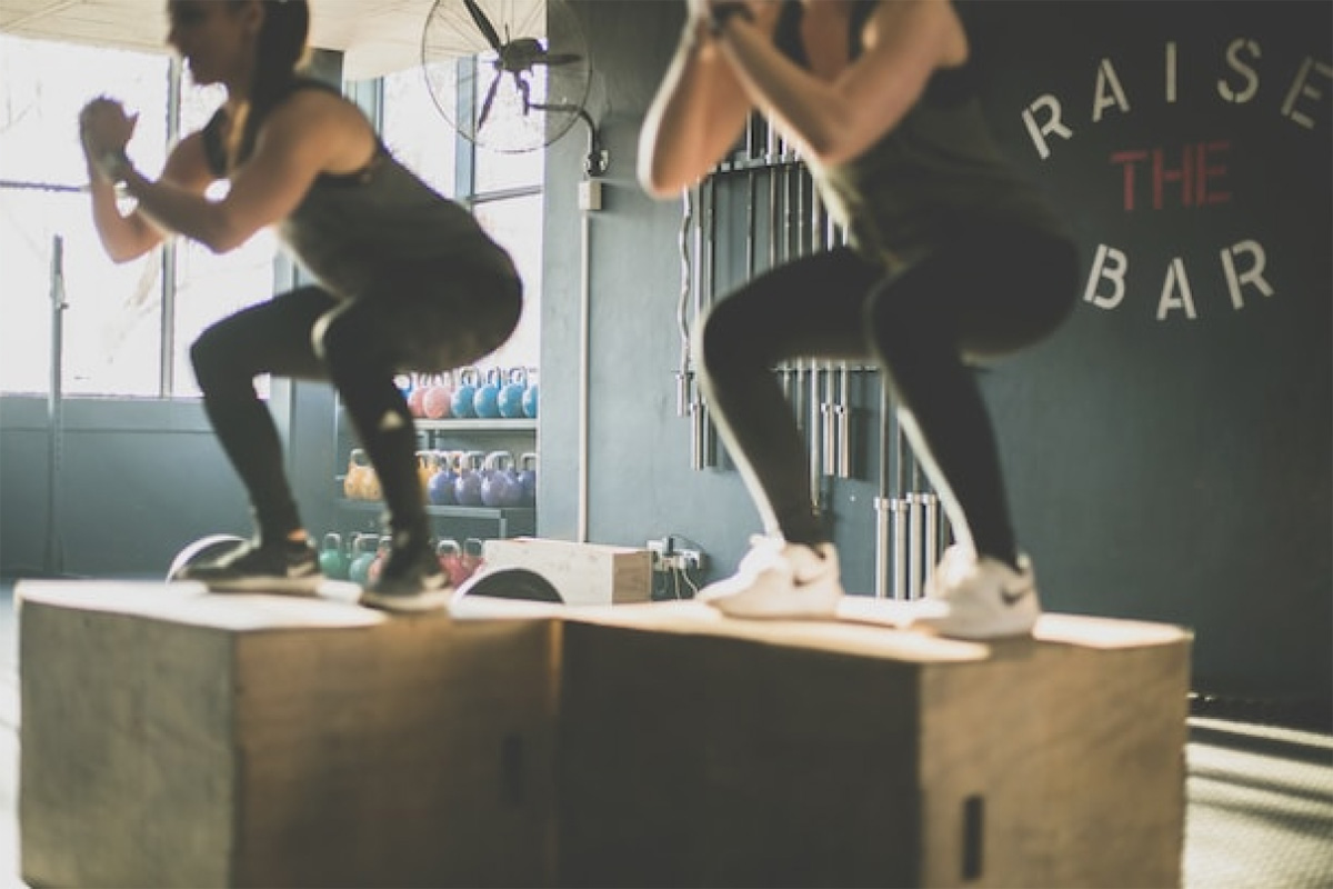 Women Squatting On Crates